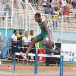  Kyron McMaster clears the final barrier during last month's Carifta Games where he earned a bronze medal. Photo credit: Dean Greenaway