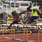 St. Kitts-Nevis' Oneil Thomas, left and BVI's Kyron McMaster coming off the last hurdle in the 400m Intermediate Hurdlers, where Thomas ran 51.83 and McMaster, 51.87. Photo: Dean "The Sportsman" Greenaway 