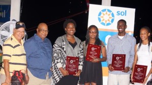 Caption: Former Presidents Johnny Hassan, left and John Lewis, with 2015 BVI Athletes of The Year Presented by Sol, Trevia Gumbs, Jr. Female AOY; Janella Thomas for her son Malaki Smith, Youth Male, AOY; Kyron McMaster, Jr. Male AOY and Beyonce DeFreitas, Youth AOY. Photo Credit: Cleave Farrington.
