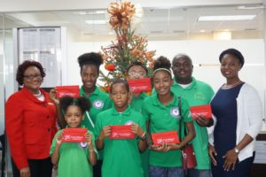 Diane Francis, Manager, Retail Banking, CIBC FirstCaribbean (L) with BVI Swim team members who competed in the 2016 OECS Swimming Championships (l-r), Khadija Sampson, Arianna Angus, Keon Sampson, Kurt Salapare, Kassia Nichols, swim coach, Elsworth Phillip, and Kishma Williams, Administrative Officer, CIBC FirstCaribbean. Missing from photo, swimmer Jaden Marshall. Photo: CIBC FirstCaribbean