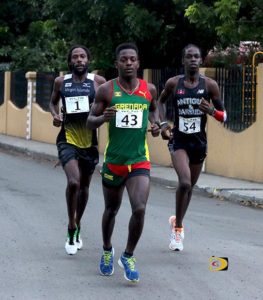 Grenada's Renon Radix, center, USVI's Shane DeeGannes, left and Antigua and Barbuda's Kalique St. Jean, battling at the 10-miles mark, making it the most competitive race in its 11-year history. Photo: Dean "The Sportsman" Greenaway