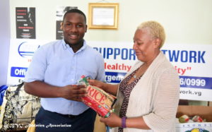 BVIAA 2017 National Youth record holder - Discus throw and Shot put Dijimon Gumbs presenting food supplies to Sylvia Simmons of FSN. Photo: BVIAA